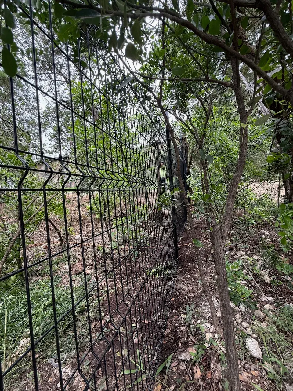 Close view of black 3D curved welded wire fence panels