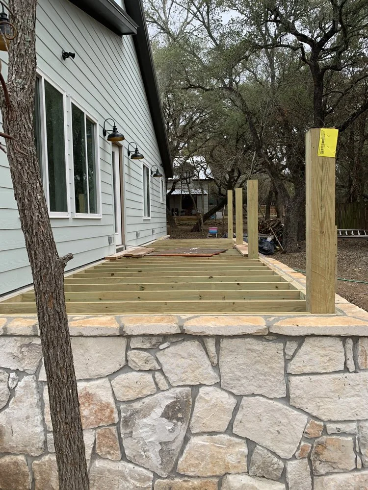 Deck framing built over stone masonry skirting