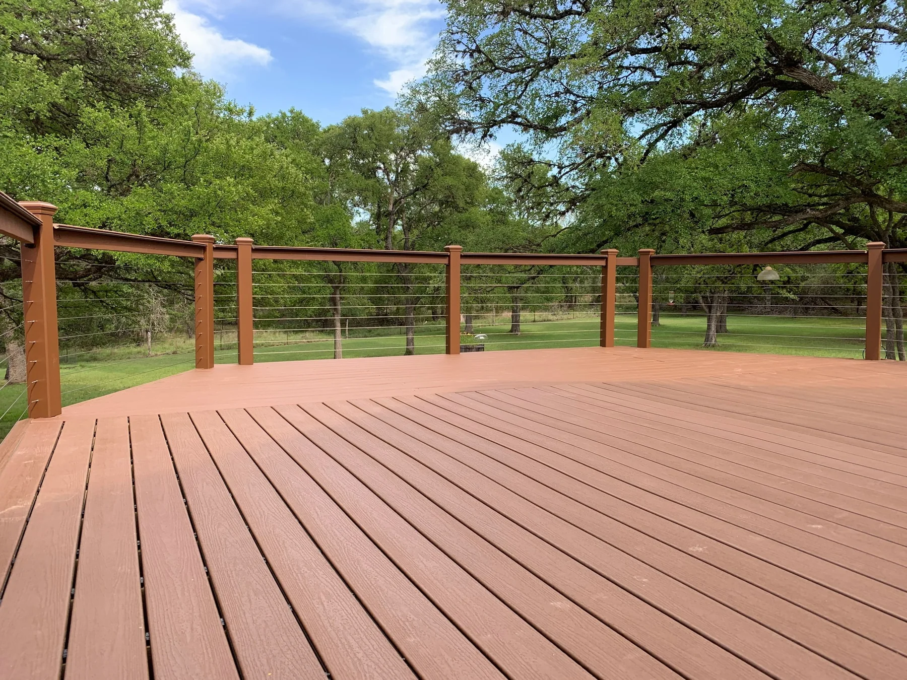 Finished custom deck with cable railing overlooking the Hill Country