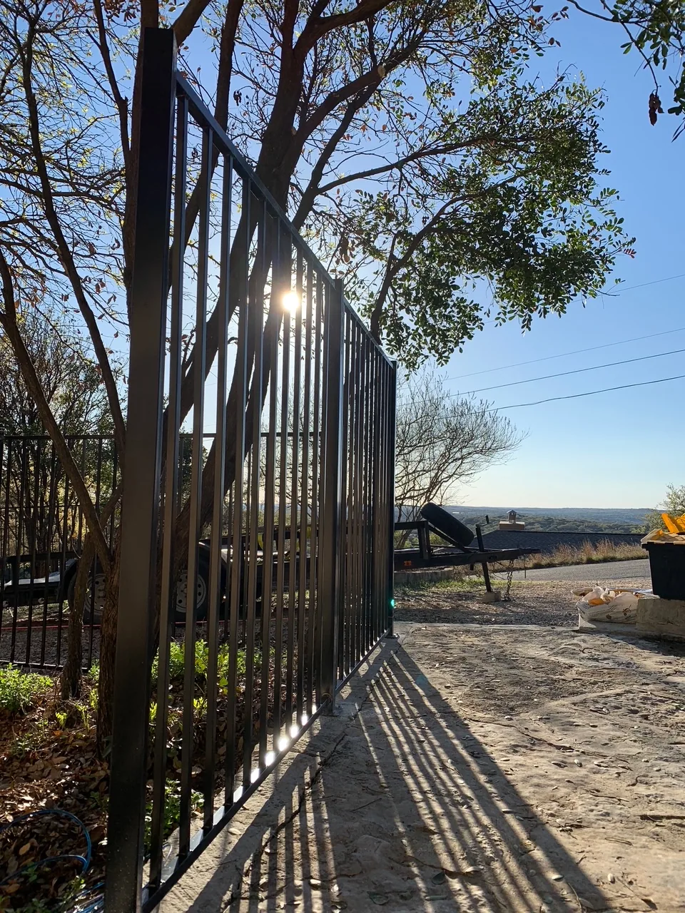 Long ornamental steel fence installed through a landscaped hillside
